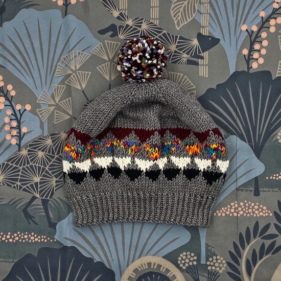 Knit bonnet NOEMI handknitted of virgin merino wool VAN BEREN