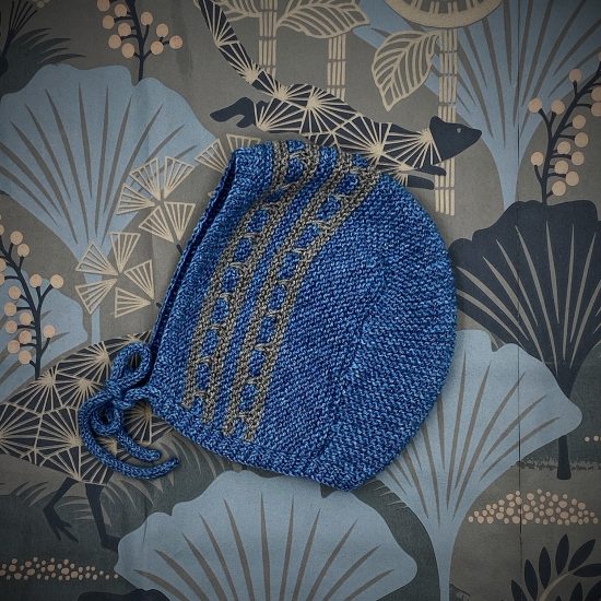 Knit bonnet ESTHER handknitted of virgin merino wool VAN BEREN