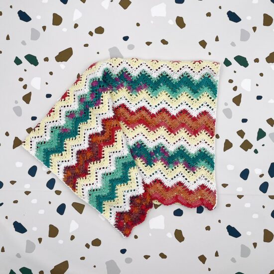 Crochet blanket ANNE in colorblocking zigzag pattern handmade of Van Beren Organic Cotton Yarn for baby girlsin Austria